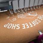 Brown bag with 'The Coffee Shop' text and coffee cup graphic.